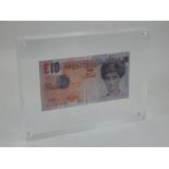 A Banksy Di-Faced ten pound note, presented within an acrylic frame, W. 20cm.