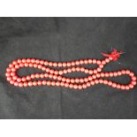 A strand of coral style prayer beads