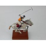 A limited edition Saturno silver and enamel polo player ornament, riding a grey pony, mounted on