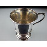 A silver christening mug, indistinctly hallmarked Birmingham 1931, with scroll handle.