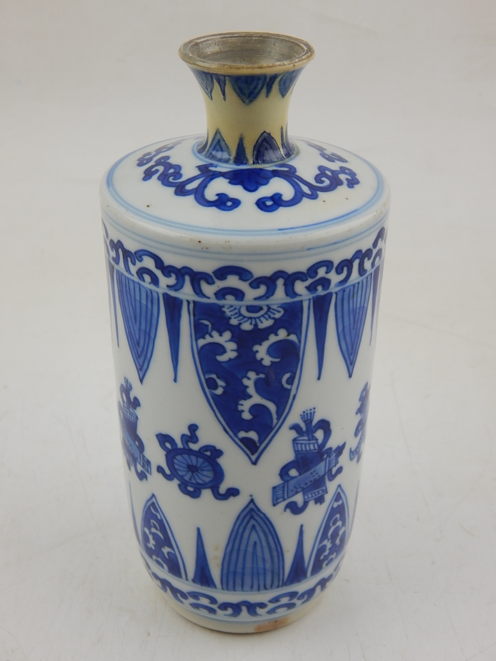 A Chinese Kangxi period blue and white vase, decorated with symbols and pendent bands, H. 17cm.