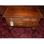 An 18th century and later walnut lowboy, with crossbanded top over two drawers, raised on cabriole