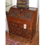 An Victorian carved Gothic oak bureau, with fall front,