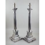 A pair of plated table lamps, of Corinthian column form, raised on stepped base, H.