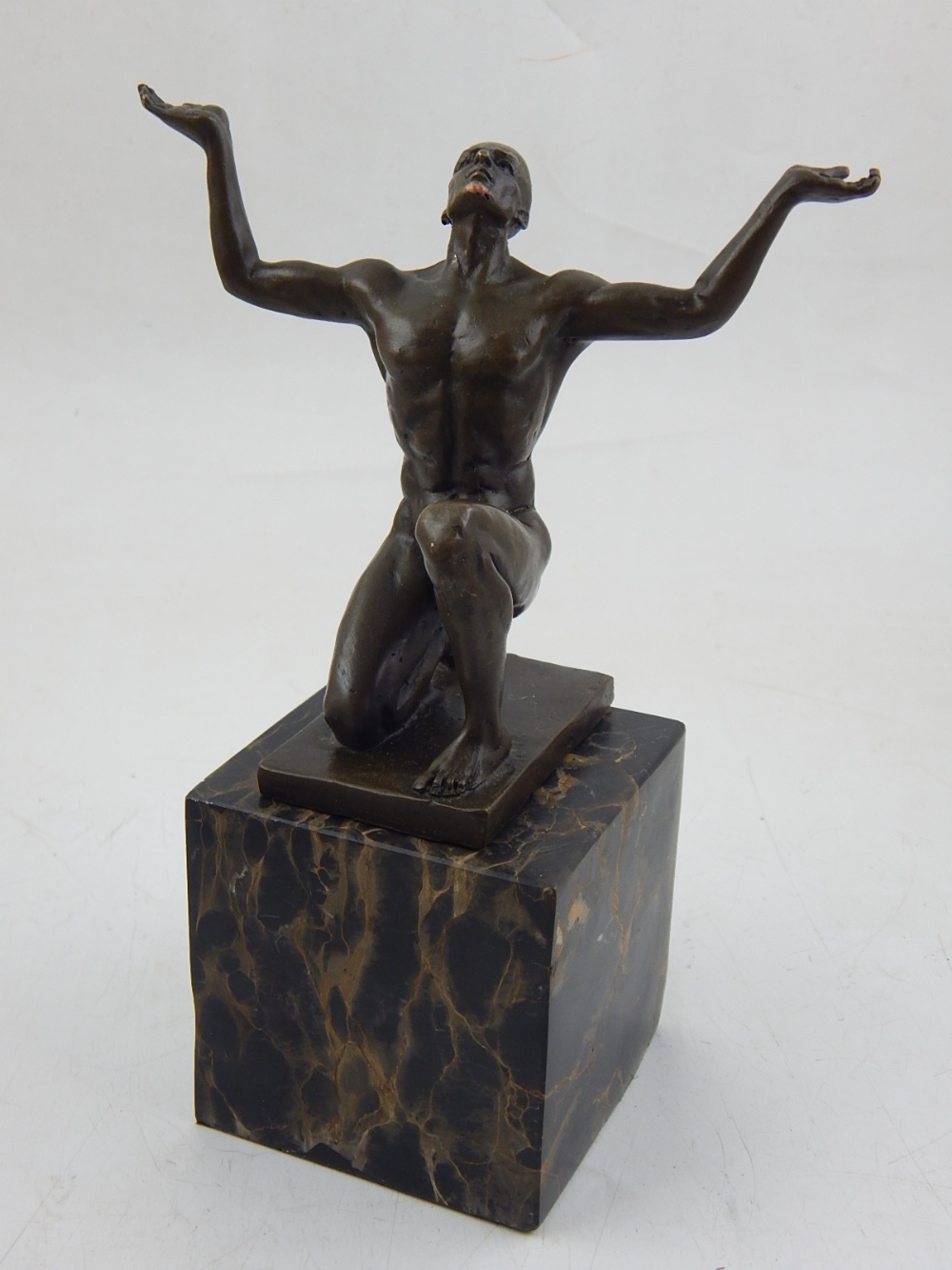 A contemporary bronze of a nude crouching man, arms outstretched and palms outwards, - Image 2 of 2