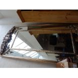 A Victorian style silvered framed rectangular wall mirror, with anthemion floral scroll pediment. H.