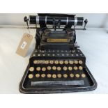 A tin plate model of a vintage typewriter.