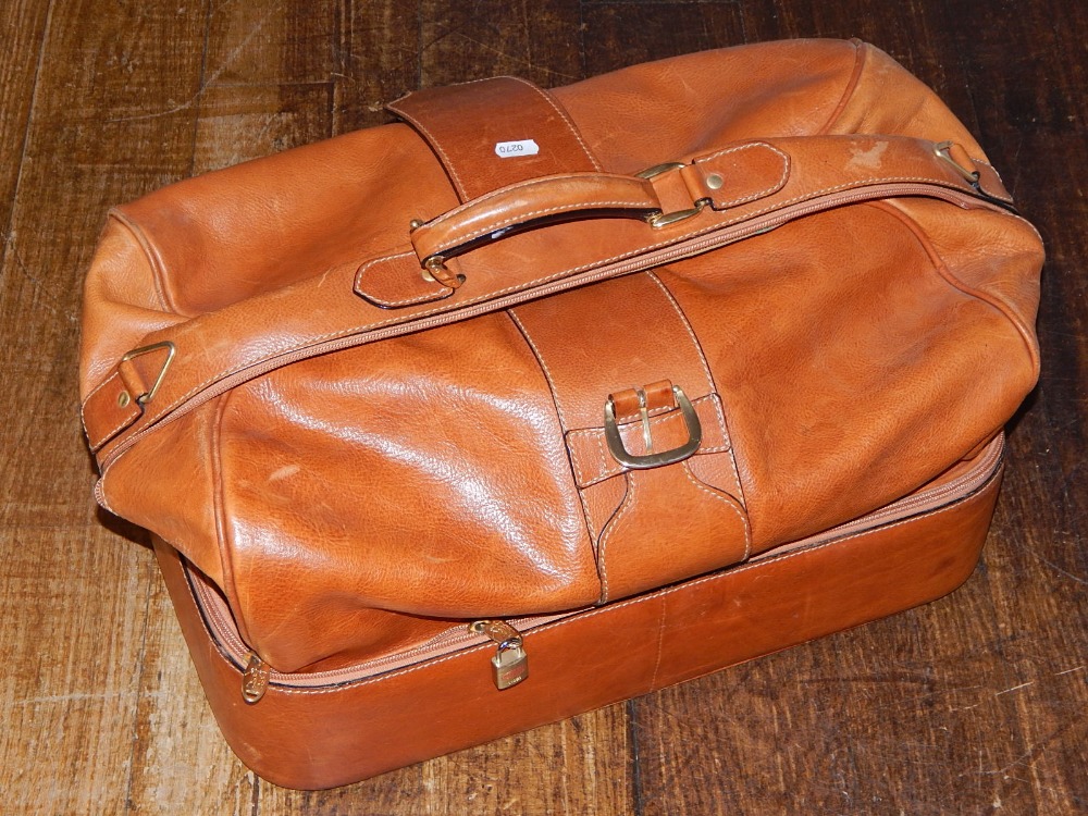 A tan leather grip bag, with brassed fittings, W. 58cm.