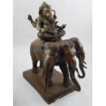 A bronze figure of Ganesha, seated on a three headed elephant, H.