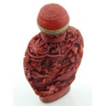 A Chinese cinnabar snuff bottle.