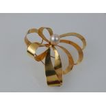 A 9ct yellow gold and pearl bow brooch.