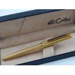 A gold plated Colibri pen, with engine turned design, boxed.