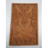 A carved Indonesian panel, two peacocks entwined 37 x 25cm.