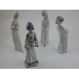 Two Nao porcelain figurines, depicting a boy and girl dressed in dressing gowns, H. 21cm, together