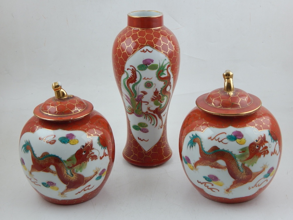 A pair of Chinese porcelain ginger jars and covers, decorated with vignettes of phoenixes and