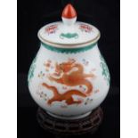 A Chinese porcelain jar and cover, polychrome decorated with dragons chasing flaming pearls, and