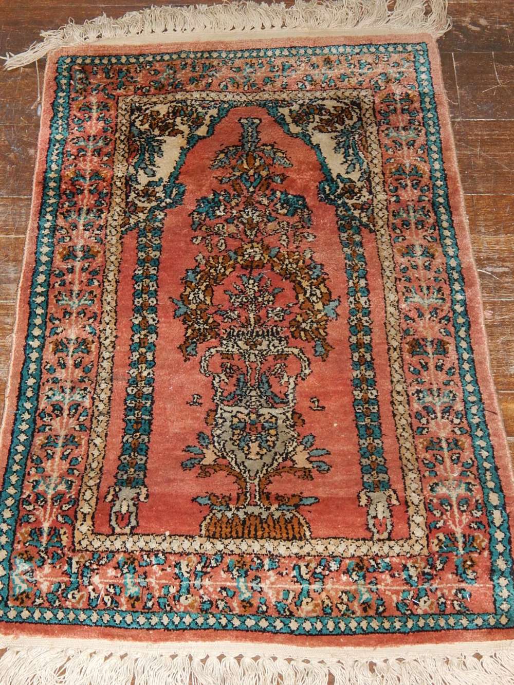 A Indian part silk prayer rug, decorated with floral mirab medallion to centre, fringed, 90cm