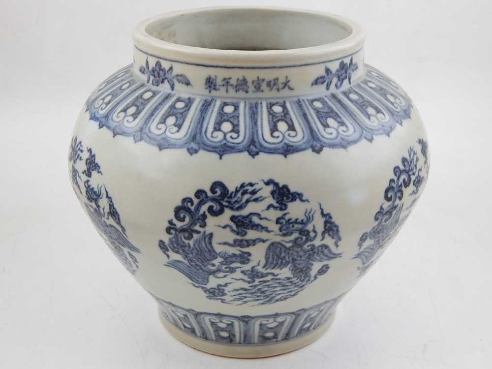 A Chinese blue and white Ming style baluster vase, decorated with vignettes of phoenixes and flaming
