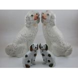 Two pairs of Victorian Staffordshire chimney dogs, smaller with green and copper lustre glaze.