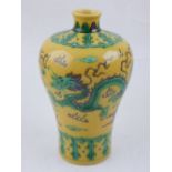 A Chinese yellow ground baluster vase, decorated with dragons chasing pearl, bears six character