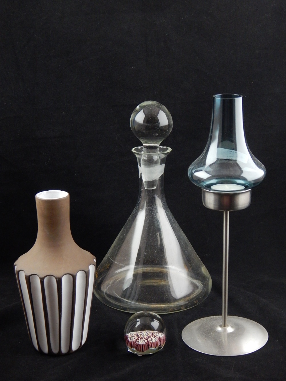 A 21st century glass decanter and stopper, together with a candleholder with glass cover, a paper