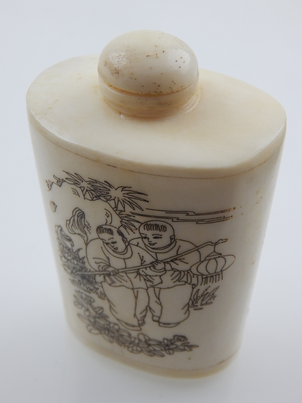 A Chinese snuff bottle, of oval tapering form, decorated with figures, H. 7cm.