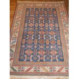 A indigo ground Turkish rug, decorated with geometric design to centre and borders, fringed. 180 x