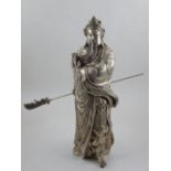 A Chinese white metal figure of Guan Gong carrying his Green Dragon crested blade, bears four