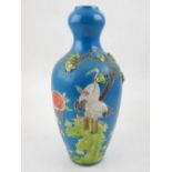 A Chinese blue ground porcelain vase, moulded with cranes and floral decoration, incised seal mark