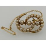 A yellow gold and seed pearl set double crescent brooch.