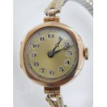 A vintage ladies 9ct gold wristwatch, the yellow metal dial with Arabic numerals, fitted expanding