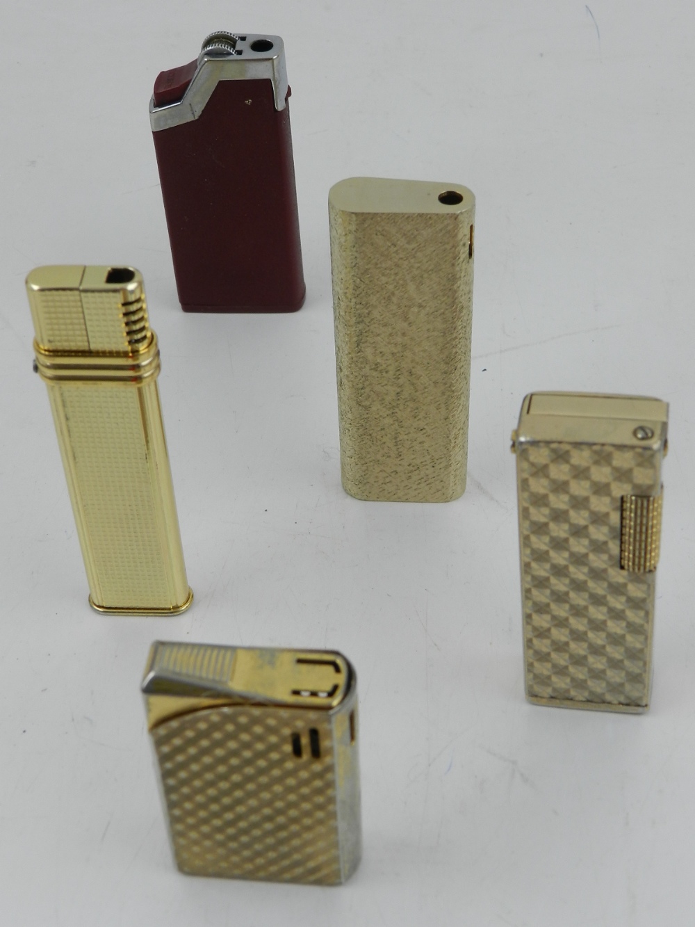 Five various cigarette lighters.