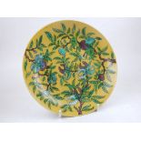 A Chinese yellow ground porcelain charger, decorated with foliage, bears six character mark to base.