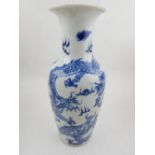 A Chinese blue and white baluster vase with everted rim, decorated with dragons chasing a flaming