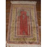 An Indian prayer rug, decorated with mirab shape medallion to centre, within many borders,