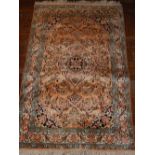 An Indian part silk prayer rug, decorated with tear drop medallion to centre on a floral ground