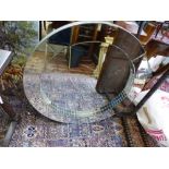 A contemporary circular wall mirror, the central plate with mosaic slip. D. 90cm