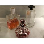 Cranberry glass silver-plated scent bottle, together with two perfume bottles.