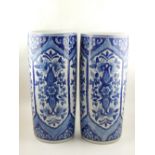 A pair of Chinese cylindrical blue and white vases, decorated with vignettes of flowers, H. 44cm