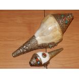 A South East Asian white metal mounted conch shell, decorated with cabouchon cut stones, together