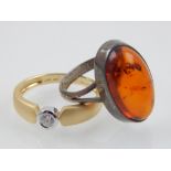 A 9 carat yellow gold and rubover white topaz ring, together with a white metal and amber ring