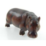 A Japanese hardwood netsuke modelled as a standing hippopotamus bears signature disc, L 5.5 cms.