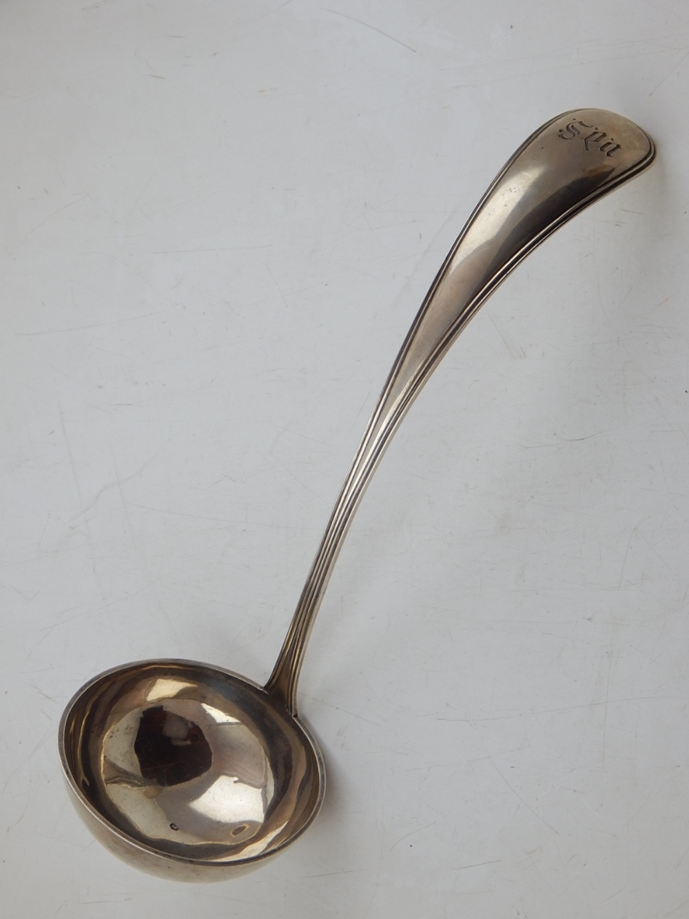 A Continental white metal ladle, thread pattern and engraved with ownership initials, 6ozt.