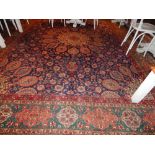 A blue ground Tabriz carpet, decorated with navette shaped medallions amongst scrolling foliage,