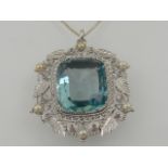 A large silver and aquamarine pendant, set large cushion cut aquamarine, within a silver and pearl