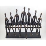 In the style of Giacometti, a cold cast bronze of seated figures.