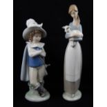 A Lladro figure of a girl holding a lamb, together with a Lladro figure of a young cavalier. H. 24cm