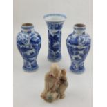 A pair of Chinese blue and white baluster shaped vases decorated with vignettes of figures H. 18cm