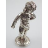 A white metal figure of a putti, signed a.