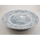 A late 19th century grey and white dish on a raised foot-rim, decorated with a Rhine-land scene, D.